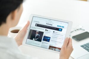 woman reading news on tablet